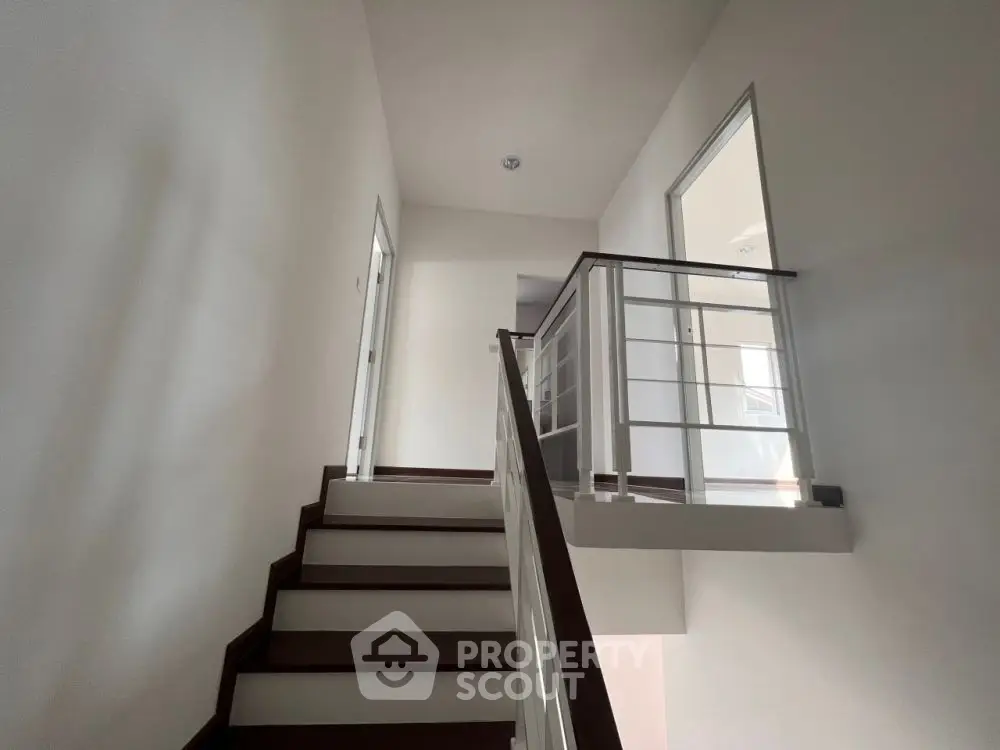 Modern staircase with sleek railing in a minimalist home interior