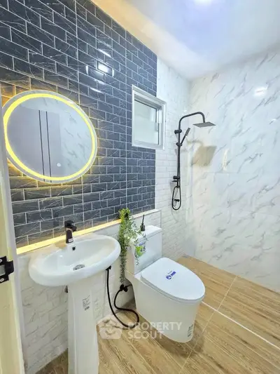 Modern bathroom with stylish tiles and illuminated mirror