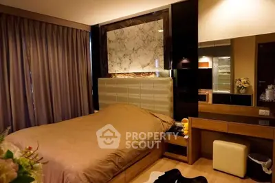 Luxurious bedroom with elegant decor and plush bedding in modern apartment.