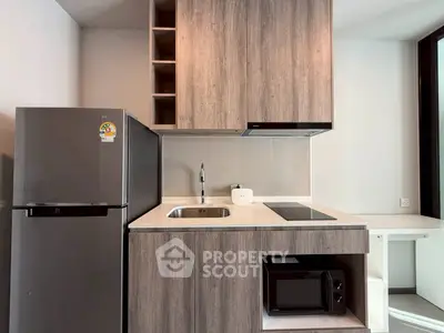 Modern kitchen with sleek cabinetry, built-in appliances, and spacious fridge in a stylish apartment.