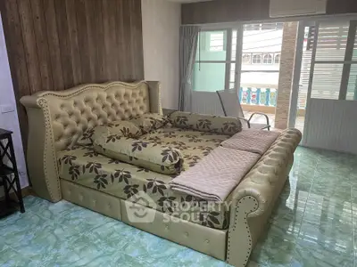 Spacious bedroom with elegant bed and balcony access in modern apartment