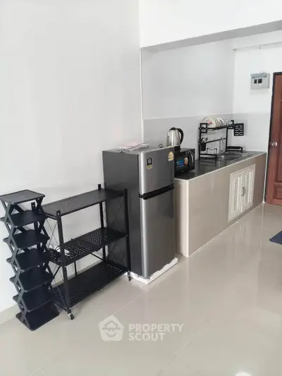 Modern kitchen with sleek fridge and ample storage space