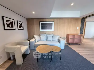 Modern living room with stylish furniture and contemporary art on the wall.