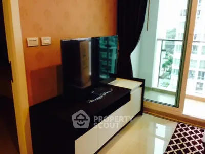 Modern living room with TV and balcony view in a stylish apartment