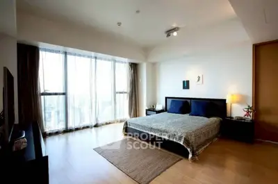 Spacious modern bedroom with large windows and elegant decor