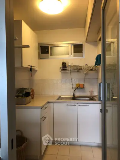 Cozy kitchen with modern cabinetry and ample counter space, perfect for culinary enthusiasts.