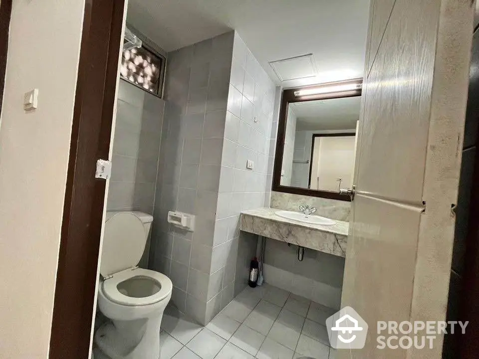 Modern bathroom with sleek design and marble countertop in a stylish apartment.