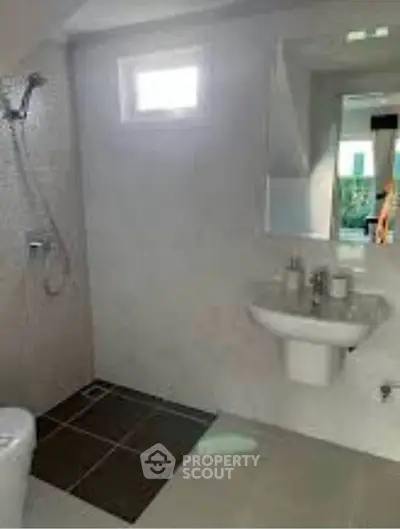 Modern bathroom with sleek fixtures and natural light, perfect for a contemporary home.