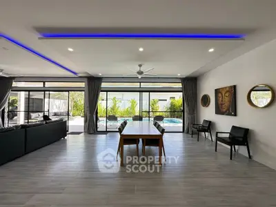 Spacious modern living room with pool view and stylish decor