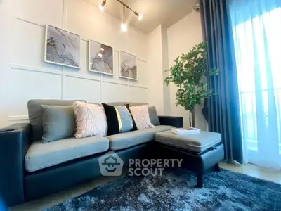 Stylish living room with modern sofa, elegant decor, and natural light