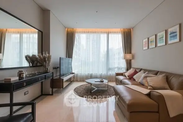 Luxurious modern living room with elegant decor and large windows.