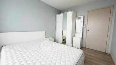 Spacious bedroom with modern furniture and ample natural light