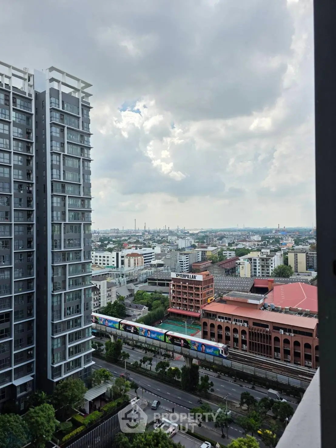 Stunning cityscape view from high-rise apartment balcony showcasing urban skyline and modern architecture.