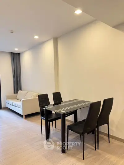 Modern living room with sleek dining area and cozy sofa, perfect for urban living.