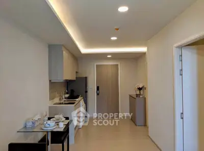 Modern open-plan kitchen and dining area with sleek design and ample lighting.