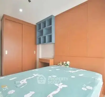 Cozy bedroom with built-in wardrobe and playful bedding in modern apartment.