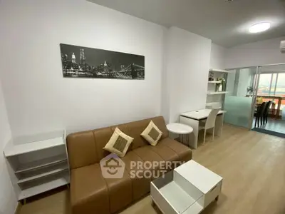 Modern living room with brown leather sofa and stylish decor in a cozy apartment.