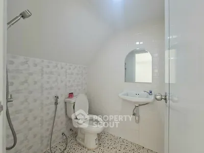 Modern bathroom with sleek white tiles and contemporary fixtures