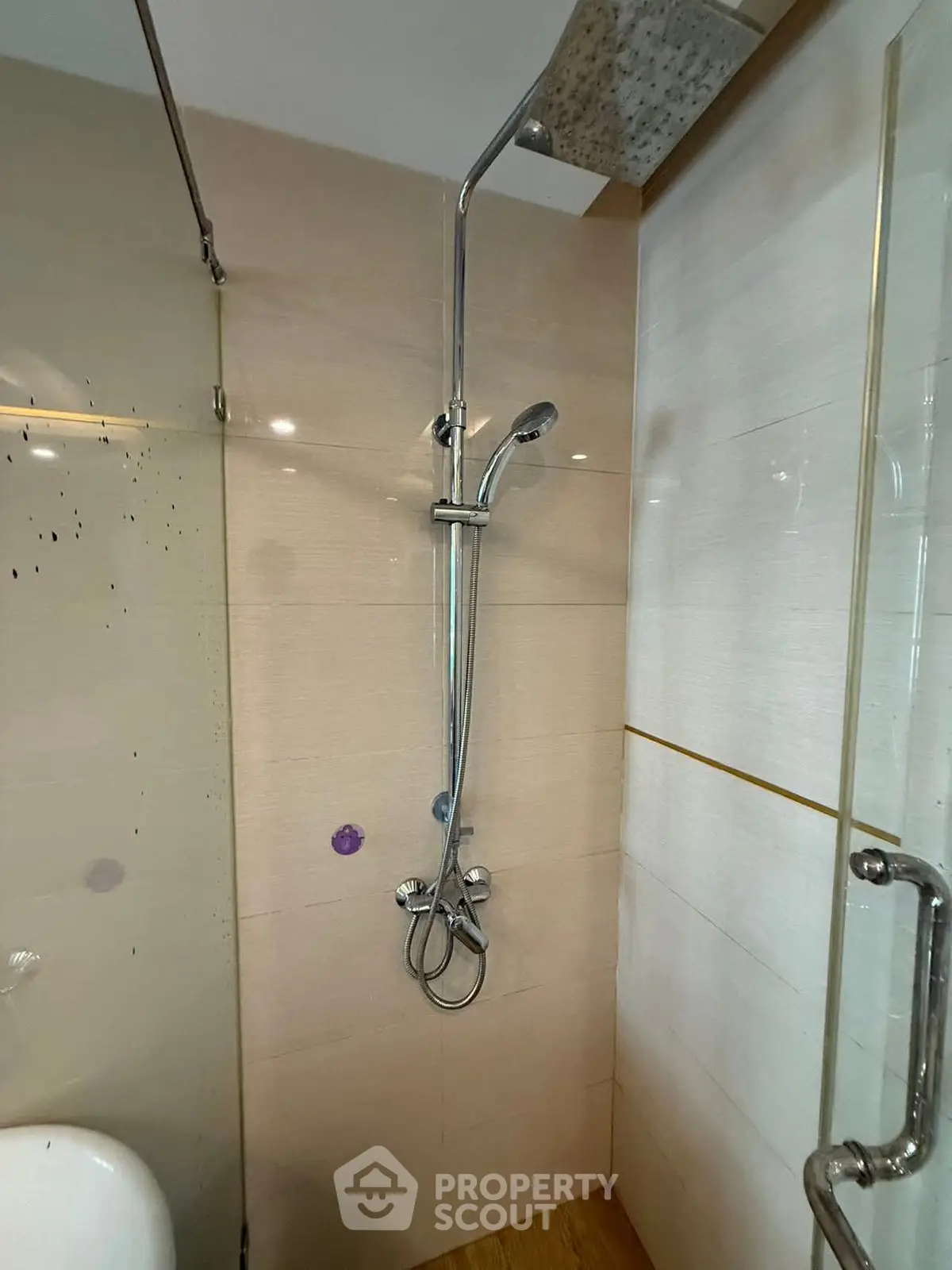 Modern bathroom with sleek shower fixtures and glass enclosure
