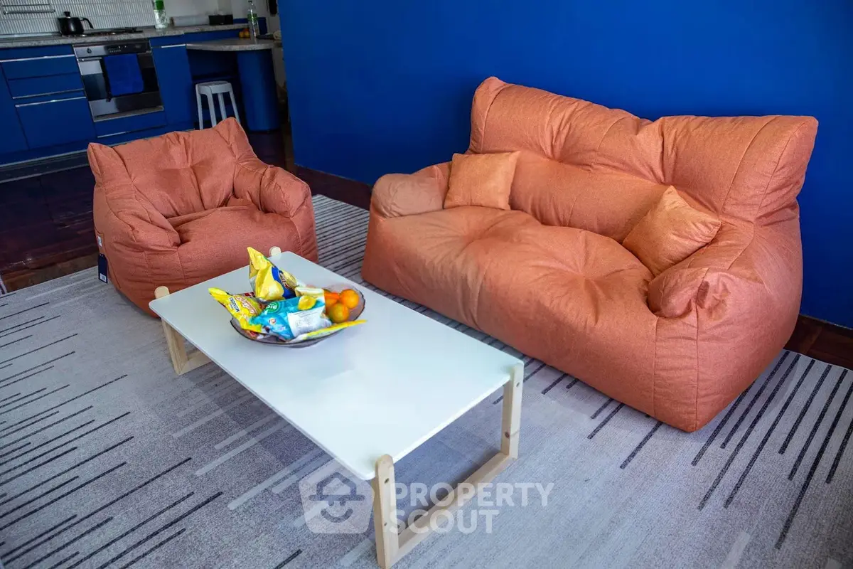 Cozy living room with modern furniture and vibrant blue accent wall