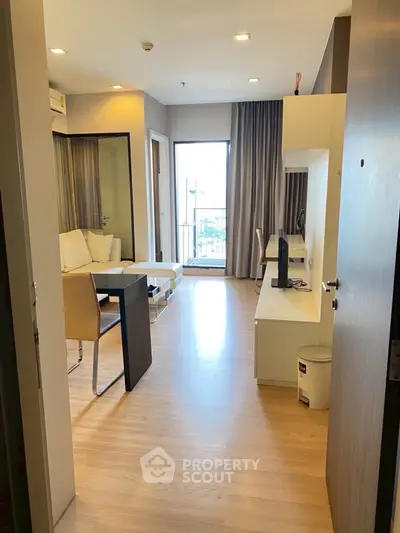 Modern living room with balcony access and stylish furnishings