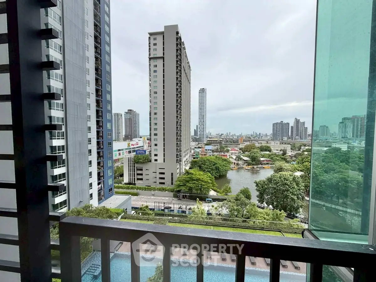 Stunning cityscape view from a high-rise balcony overlooking a pool and river.