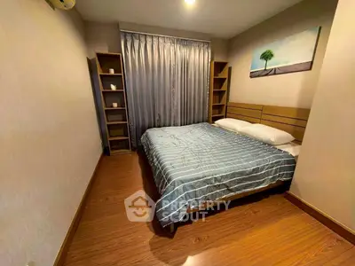 Cozy bedroom with wooden flooring and modern decor in a stylish apartment.