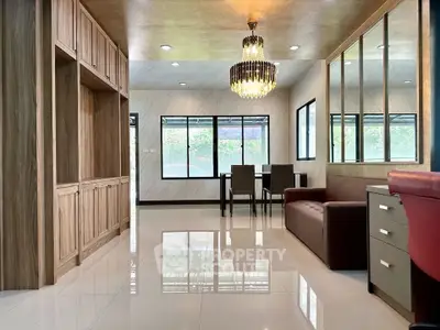 Spacious modern living room with elegant chandelier and large windows