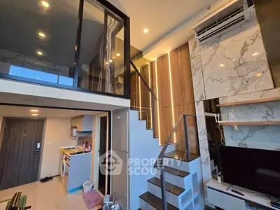 Modern duplex apartment with stylish interior, featuring a loft area, sleek kitchen, and elegant staircase.