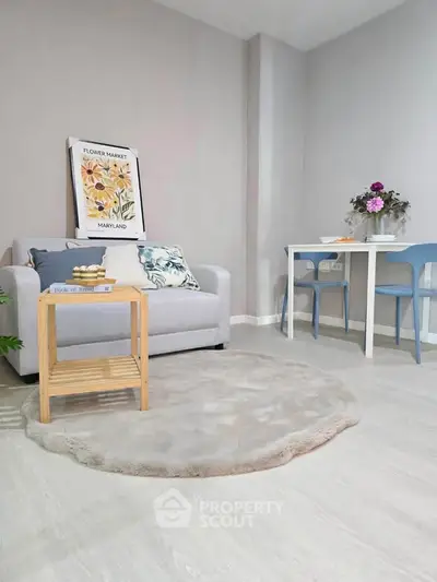 Charming living room with cozy sofa, stylish decor, and elegant dining area, perfect for modern living.