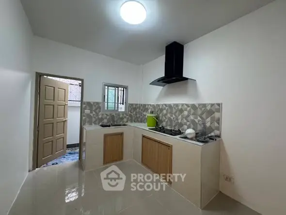 Modern kitchen with sleek design and gas stove, perfect for culinary enthusiasts.