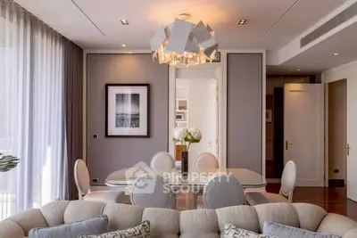Elegant living and dining area with modern chandelier and stylish decor