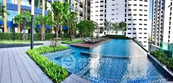 Luxurious high-rise apartment complex with stunning outdoor pool and lush greenery.