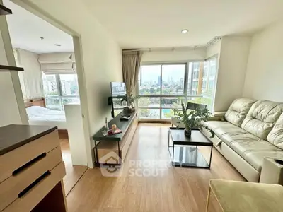 Bright and modern living room with city view, featuring cozy seating and stylish decor.
