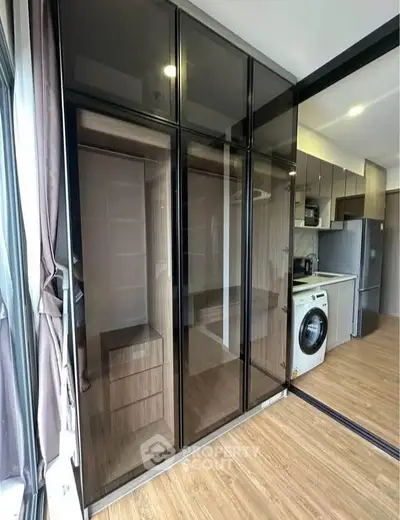 Modern kitchen with sleek cabinets and built-in washing machine