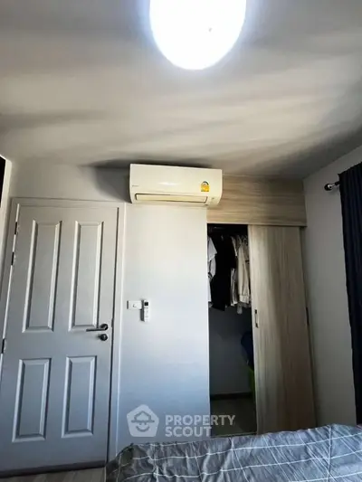 Cozy bedroom with air conditioning and built-in wardrobe, perfect for comfortable living.