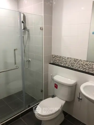 Modern bathroom with glass shower and sleek tile design