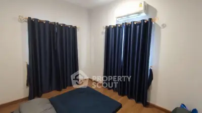 Cozy bedroom with dark curtains and air conditioning, perfect for restful nights.