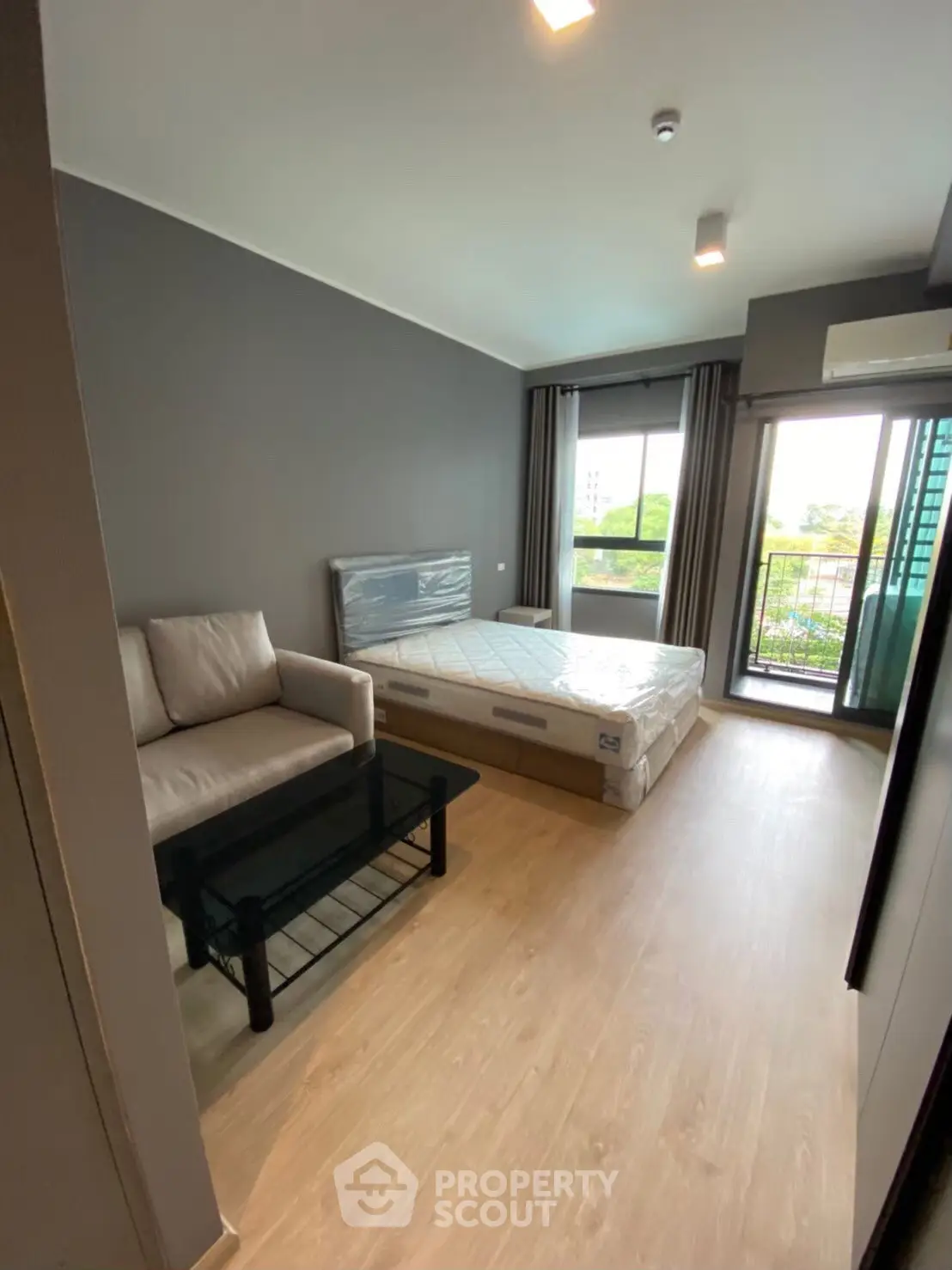 Modern bedroom with balcony view in stylish apartment