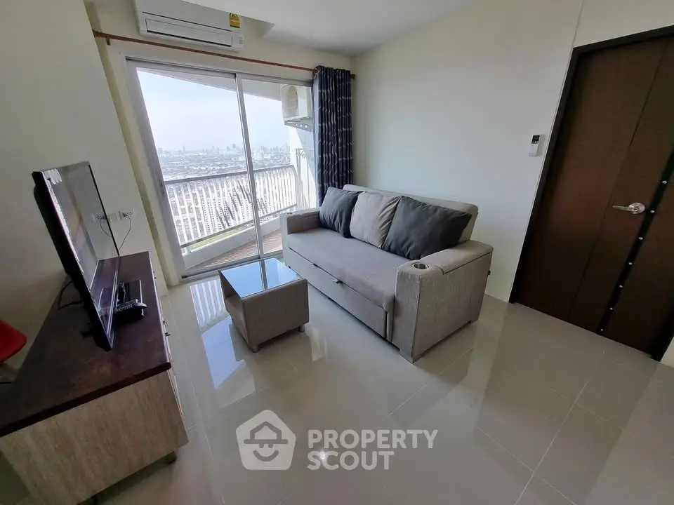 Modern living room with city view, featuring sleek furniture and large windows for natural light.