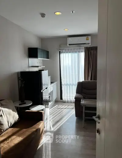 Cozy living room with modern furniture and natural light in a stylish apartment.