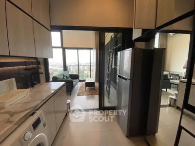 Modern kitchen with open layout leading to a bright living room with city view.