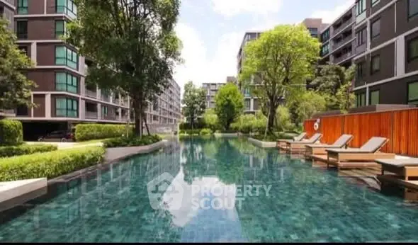 Luxurious residential complex with serene pool and lush greenery, perfect for relaxation and leisure.