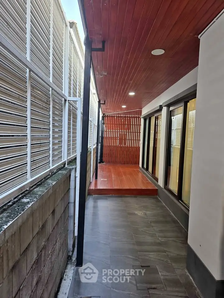 Modern exterior corridor with wooden ceiling and sleek design
