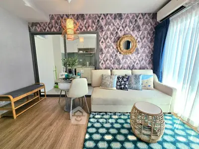 Stylish living room with modern decor, patterned wallpaper, and natural light