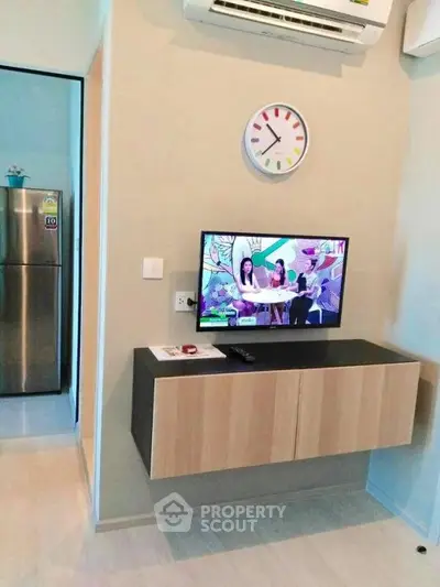 Modern living room with wall-mounted TV and sleek storage unit