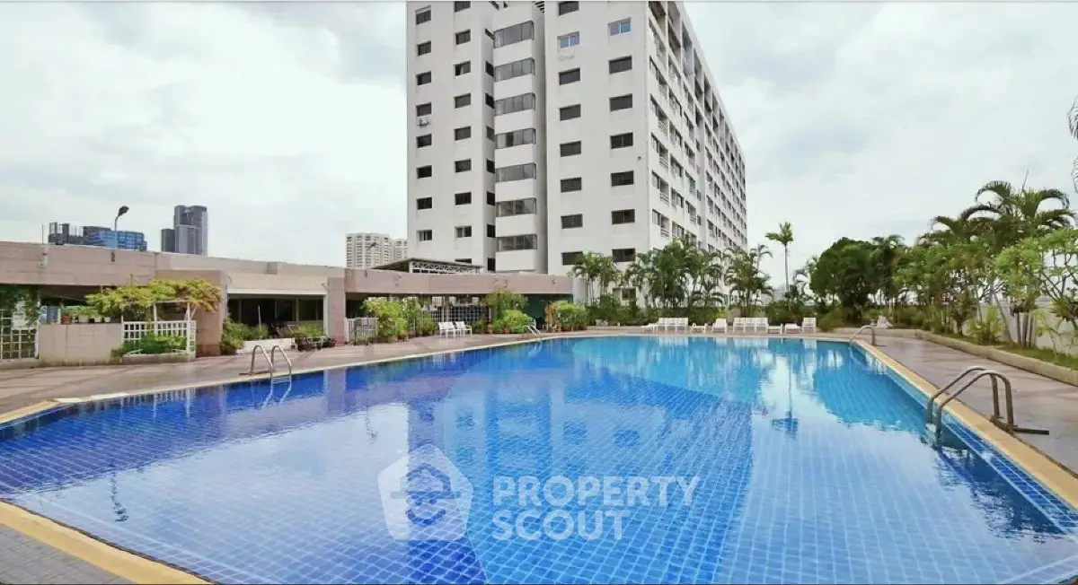 Luxurious high-rise building with stunning rooftop pool and lush greenery, perfect for urban living.