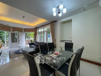 Spacious living room with modern dining area and garden view