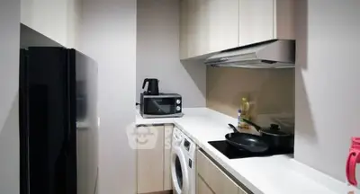 Modern compact kitchen with sleek appliances and efficient layout.