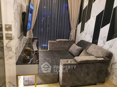 Luxurious living room with plush gray sofa and marble accents, perfect for modern urban living.
